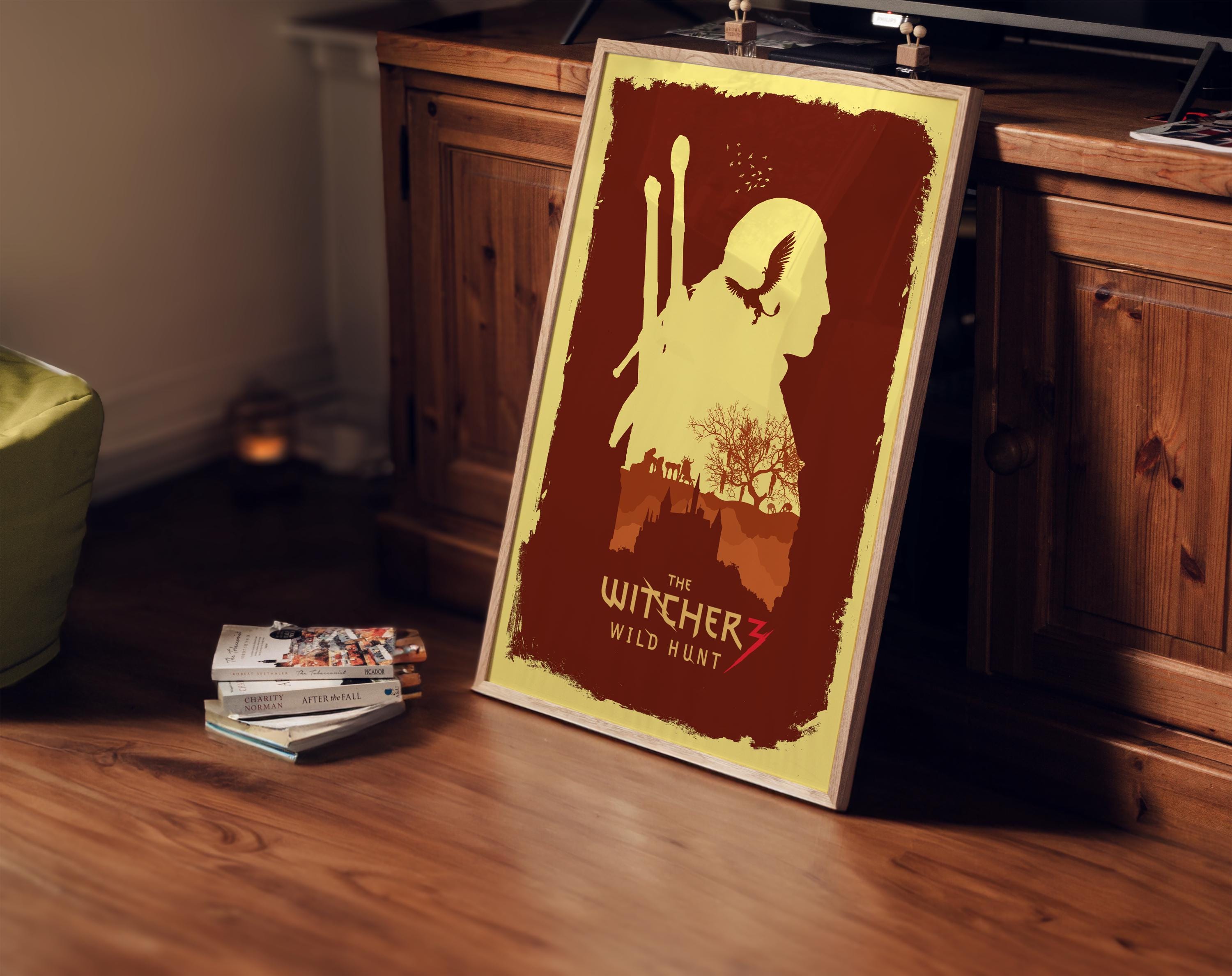 poster di the witcher 3 incorniciato, appoggiato a mobile della tv